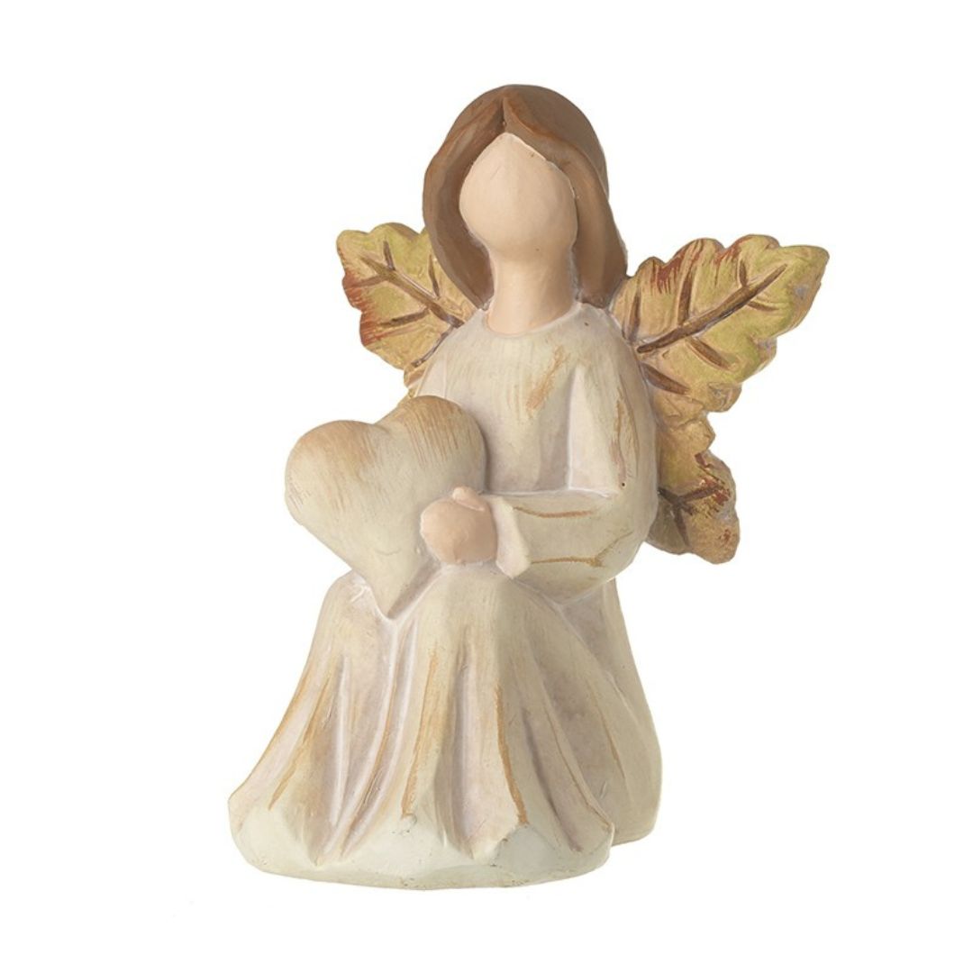 Autumn angel made from clay, and hand painted in neutral tones. Wings are oak leaves in autumnal colours, and she's sitting, hlding a heart in her lap
