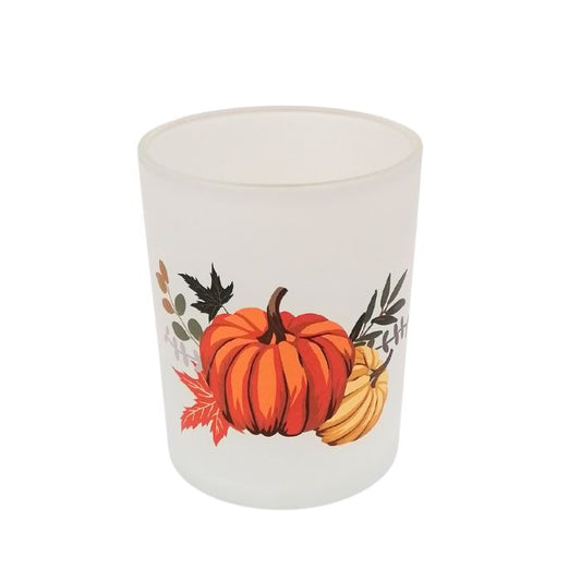 Candle with pumpkins and leaves design on a white background showing from the top angle