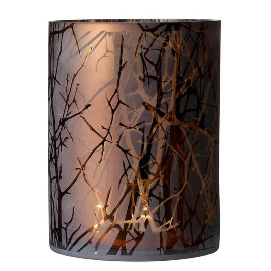 Decorative candle holder with branch pattern on a white background
