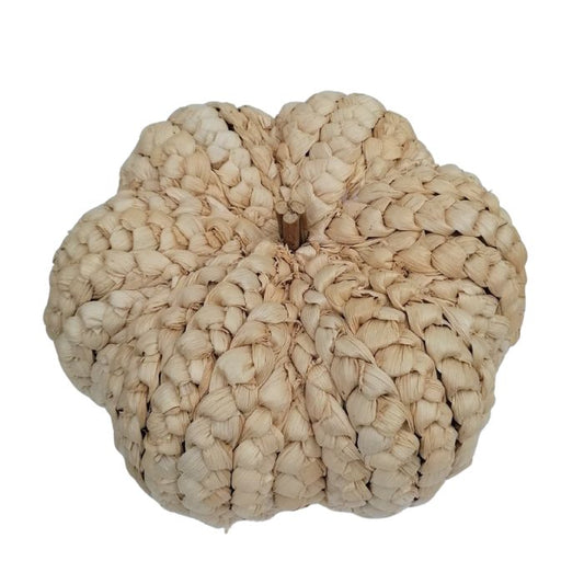 Woven beige pumpkin decoration on a white background from above