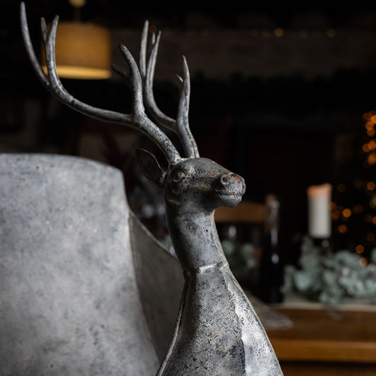 Decorative deer figure with antlers in a dimly lit room.