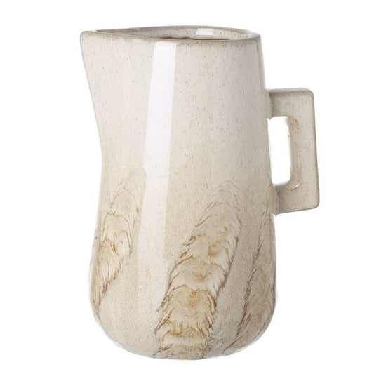 Beige ceramic pitcher with a handle on a white background