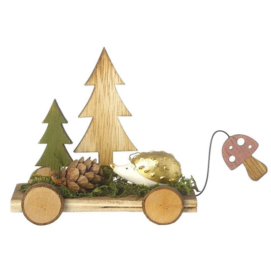 Wooden decorative item with trees, a hedgehog, and a mushroom on a white background