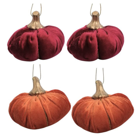 Four velvet pumpkins in red and orange on a white background