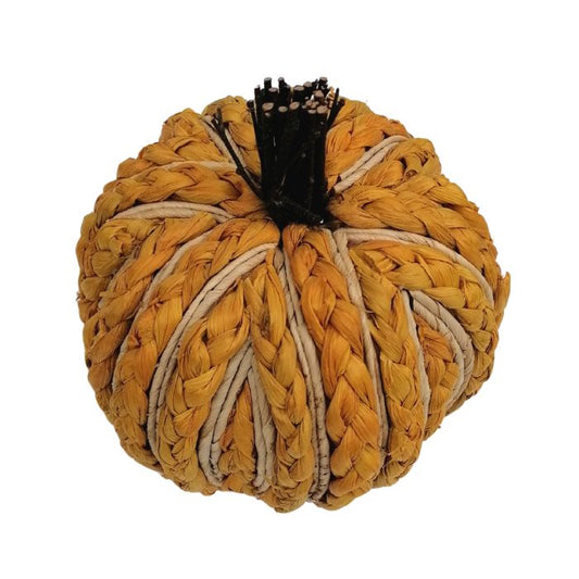 Woven ochre yellow pumpkin decoration on a white background from above