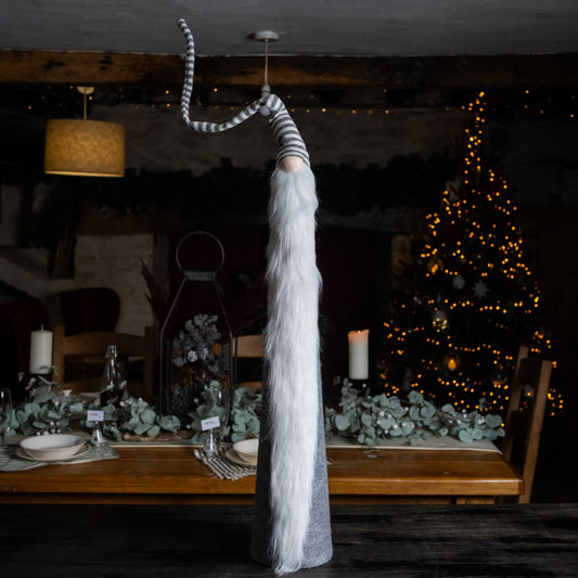 Tall grey stripe fabric gonk on island unit against Christmas background