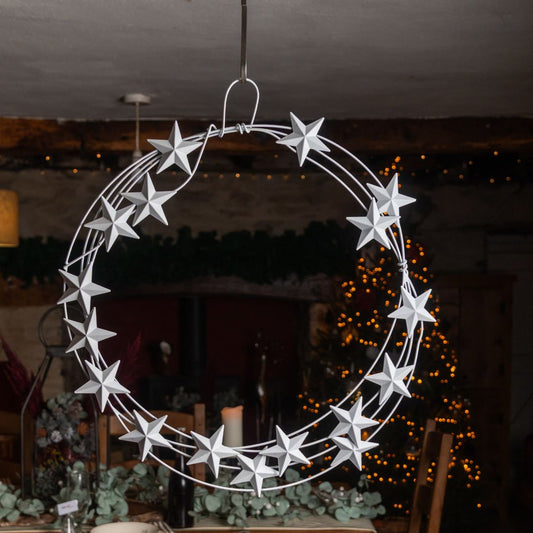 Decorative metal wreath with stars hanging indoors