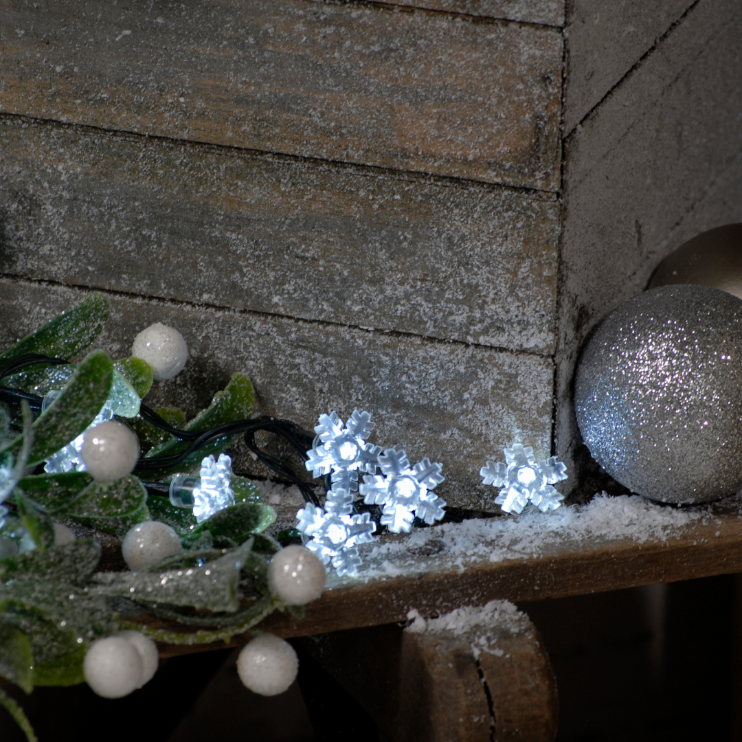 Close up on pew display of battery snowflake Christmas lights