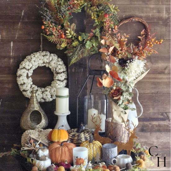 A collection of seasonal products and gifts that are perfect for the Autumn season, shown against a wooden background