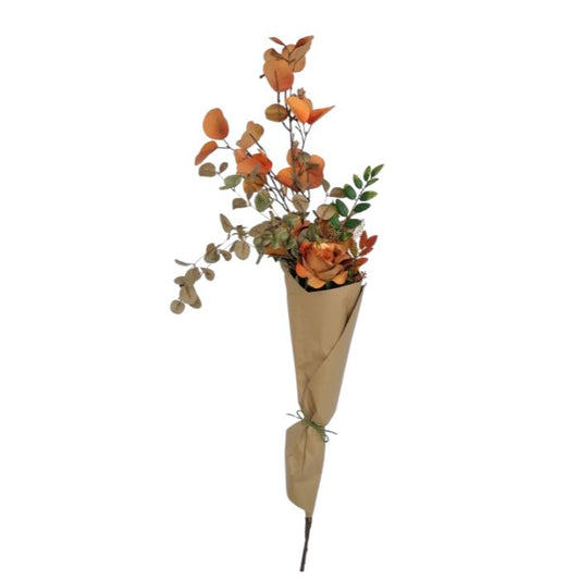 Bouquet of artificial flowers wrapped in brown paper on a white background
