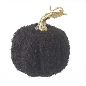 The unusual black pumpkin with a gold stalk and a close up of the textured fabric of the pumpkin