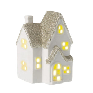 White unglazed ceramic light up house ornament with a liberally glittered roof and eaves in champagne gold glitter.  LED light up function that is accessed from underneath
