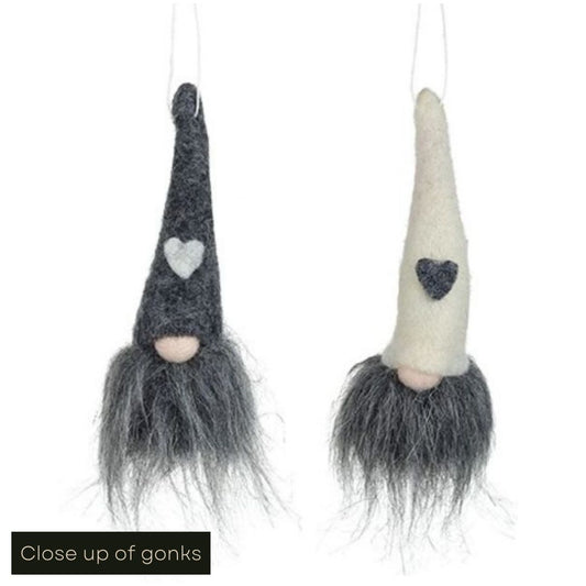 White cut out product image showing a grey and a white fabric gonk hanging in a much larger scale to the image with 4 gonk tree decorations in