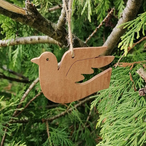 The dove cinnamon Christmas tree decoration against the green of a tree