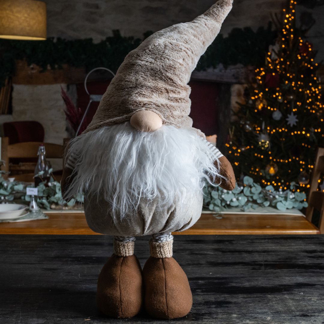 Festive gonk in neutral browns standing on a unit with festive background