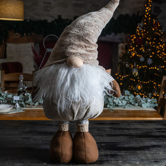 Festive gonk in neutral browns standing on a unit with festive background