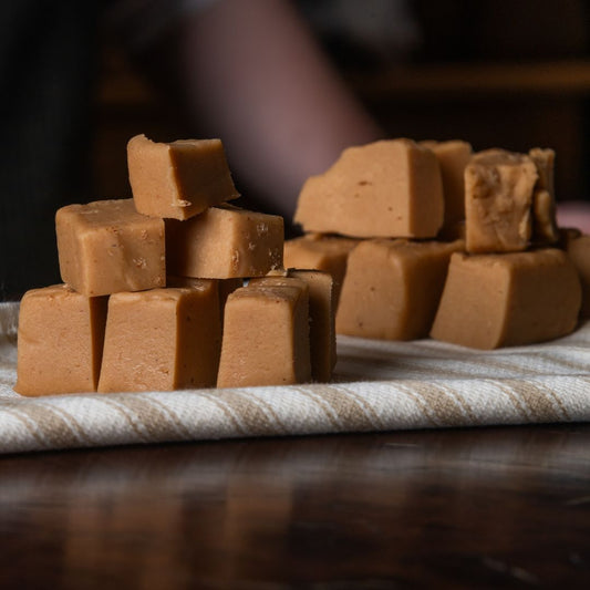 Cubes of gingerbread fudge on a striped cloth with a blurred background