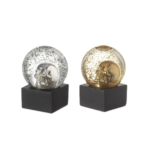 Glitter skull decoration is a metallic skull in  either silver or gold, sitting within a globe.  turn the globe upside down and you get holographic glitter falling down around