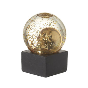 Picture of the gold glitter skull decoration, a gold skull sitting within a snowglobe.  Although it looks like gold glitter int e picture, its actually more green/blue