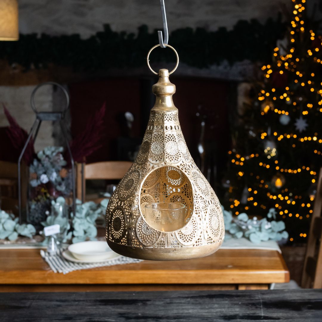 Decorative hanging lantern on a table with a blurred festive background