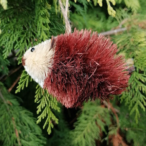 Hedgehog tree decoration against the green of a tree