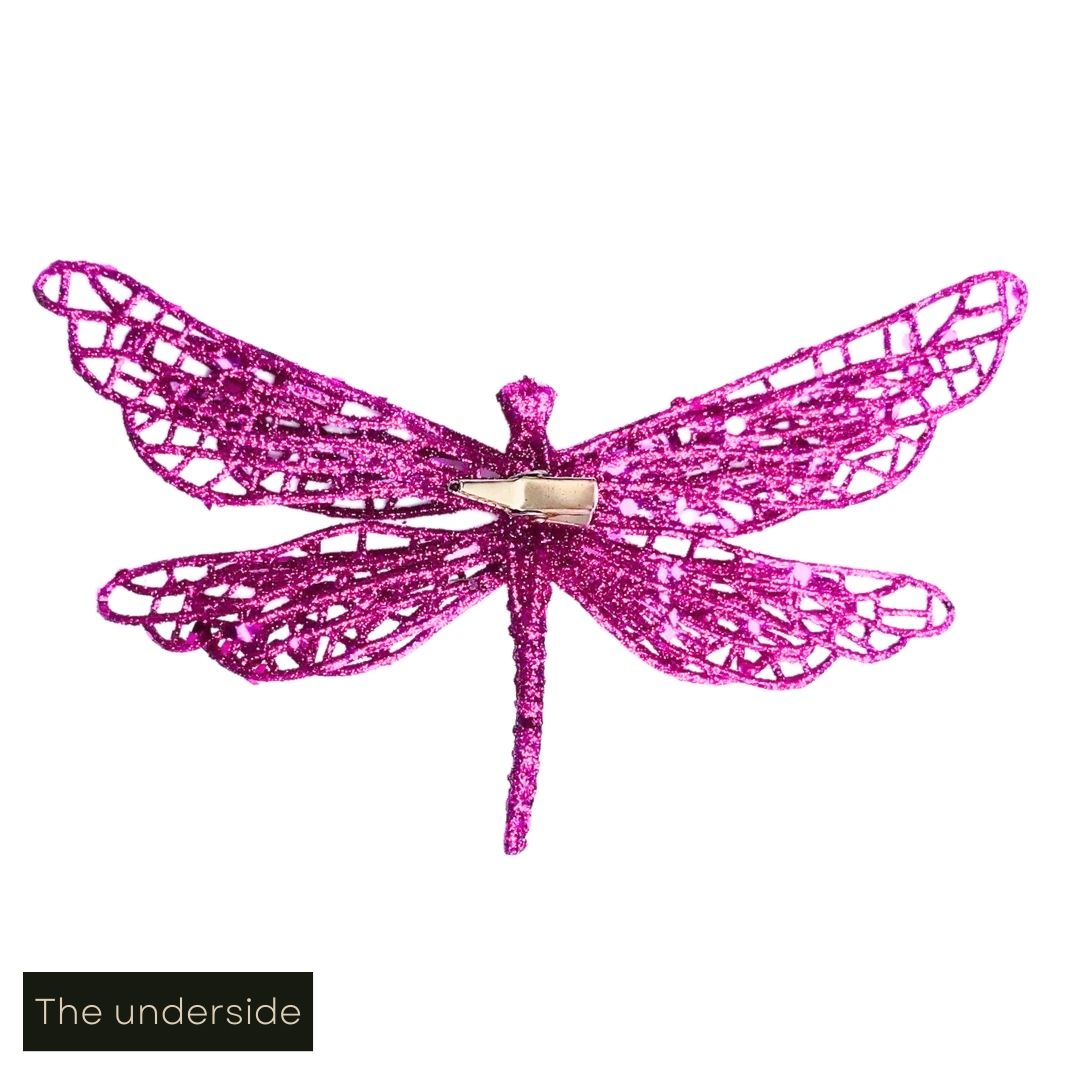 White cut out image showing the underside of the hot pink glittered butterfly clip on decoration, including a close up of the clip