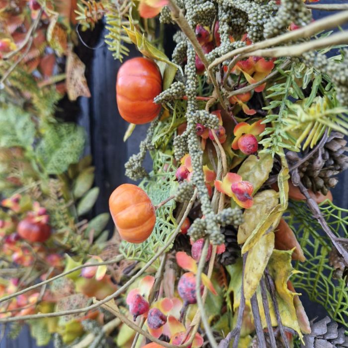 Close up of the large autumnal foliage wreath, showing mossy branches and bittersweet berries