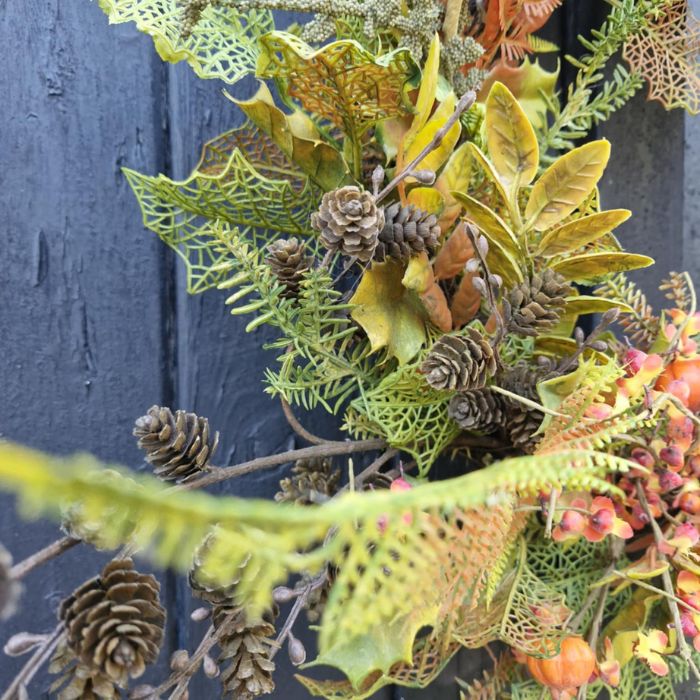 Close up of the large autumnal foliage wreath showing some of the pine cones