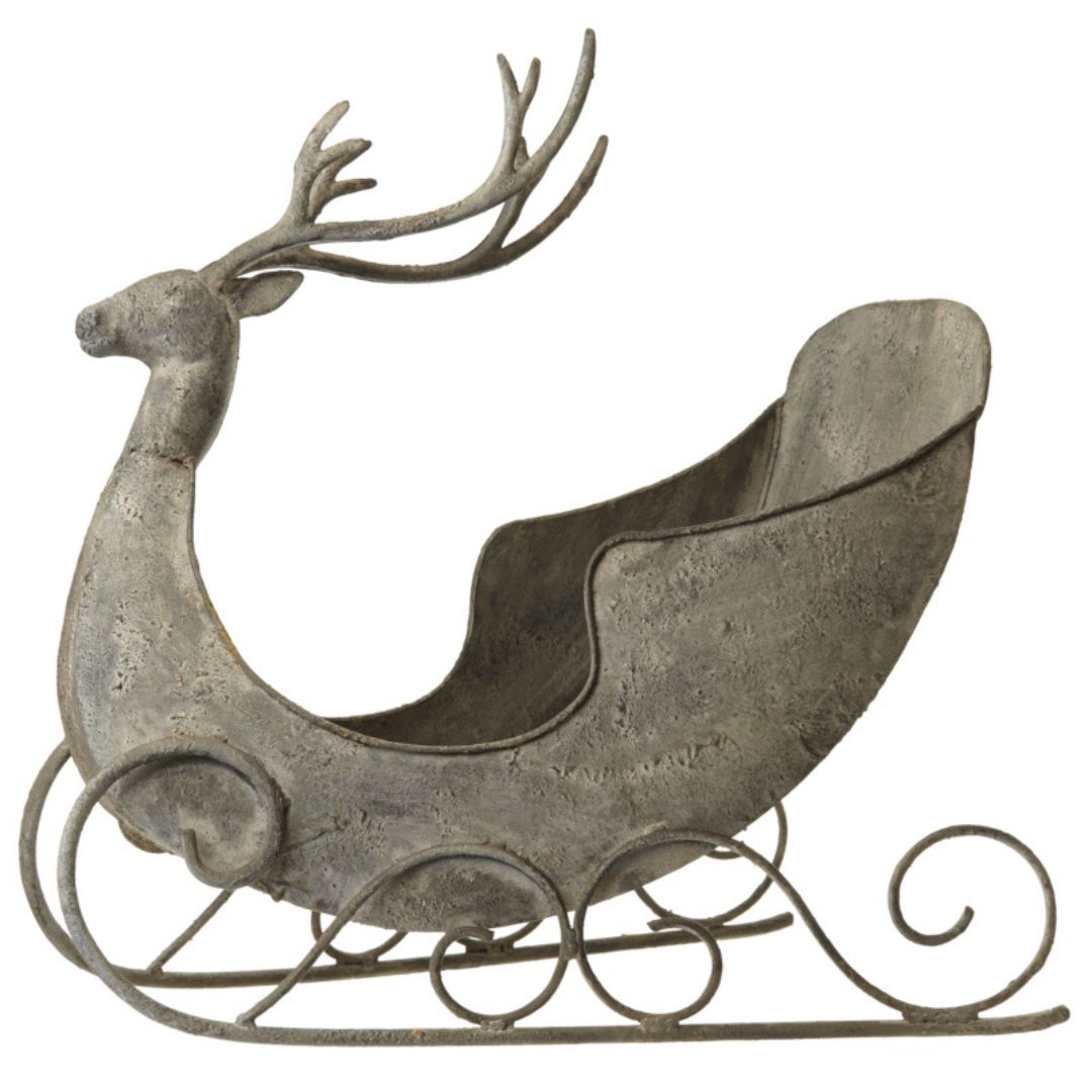 Decorative metal reindeer with sleigh on a white background
