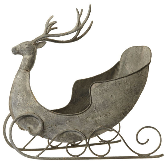 Decorative metal reindeer with sleigh on a white background