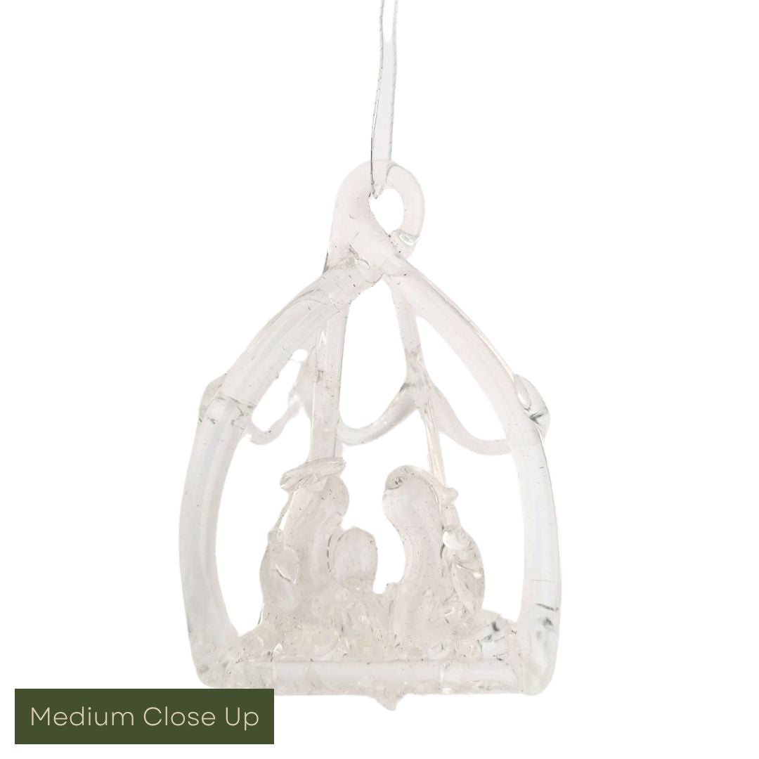 Decorative glass nativity scene with cradle on a white background