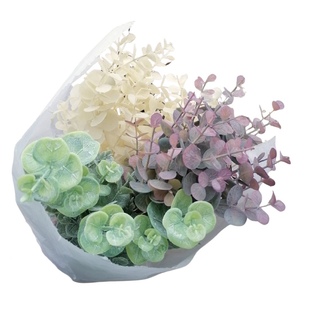 Mixed purple, green and white euclayptus foliage in a hand tied bouquet, wrapped with string and white tissue paper