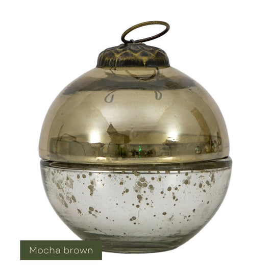 Mocha brown glass candle with speckled pattern on a white background