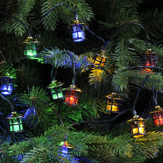 String lantern lights with multi-colored bulbs displayed on a Christmas tree.