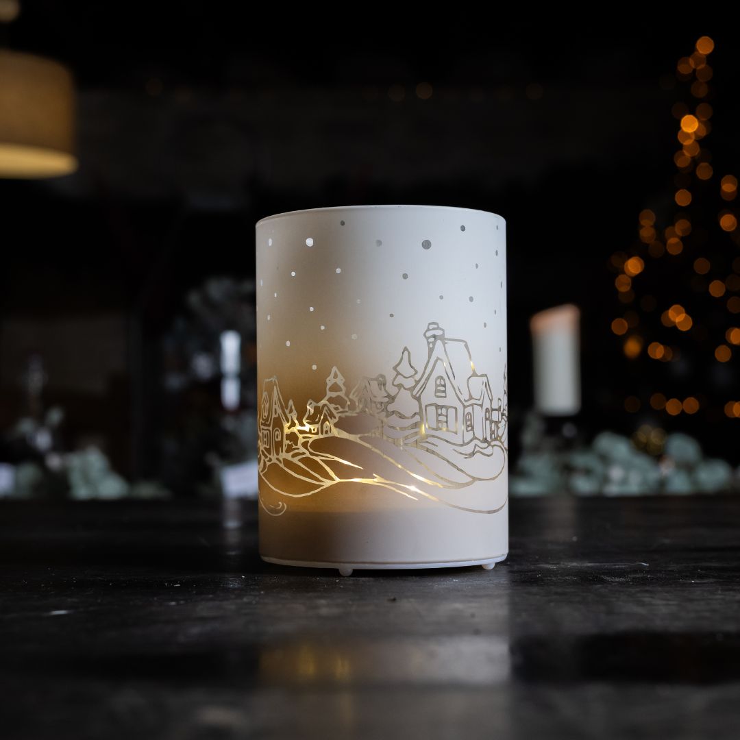 Decorative night light with a winter scene design on a dark background