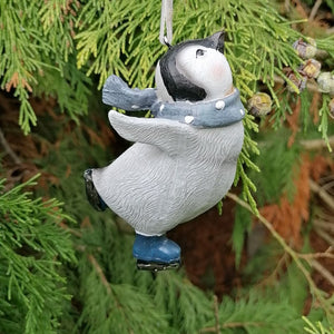Penguin Christmas decoration wearing a blue and white spotty scarf