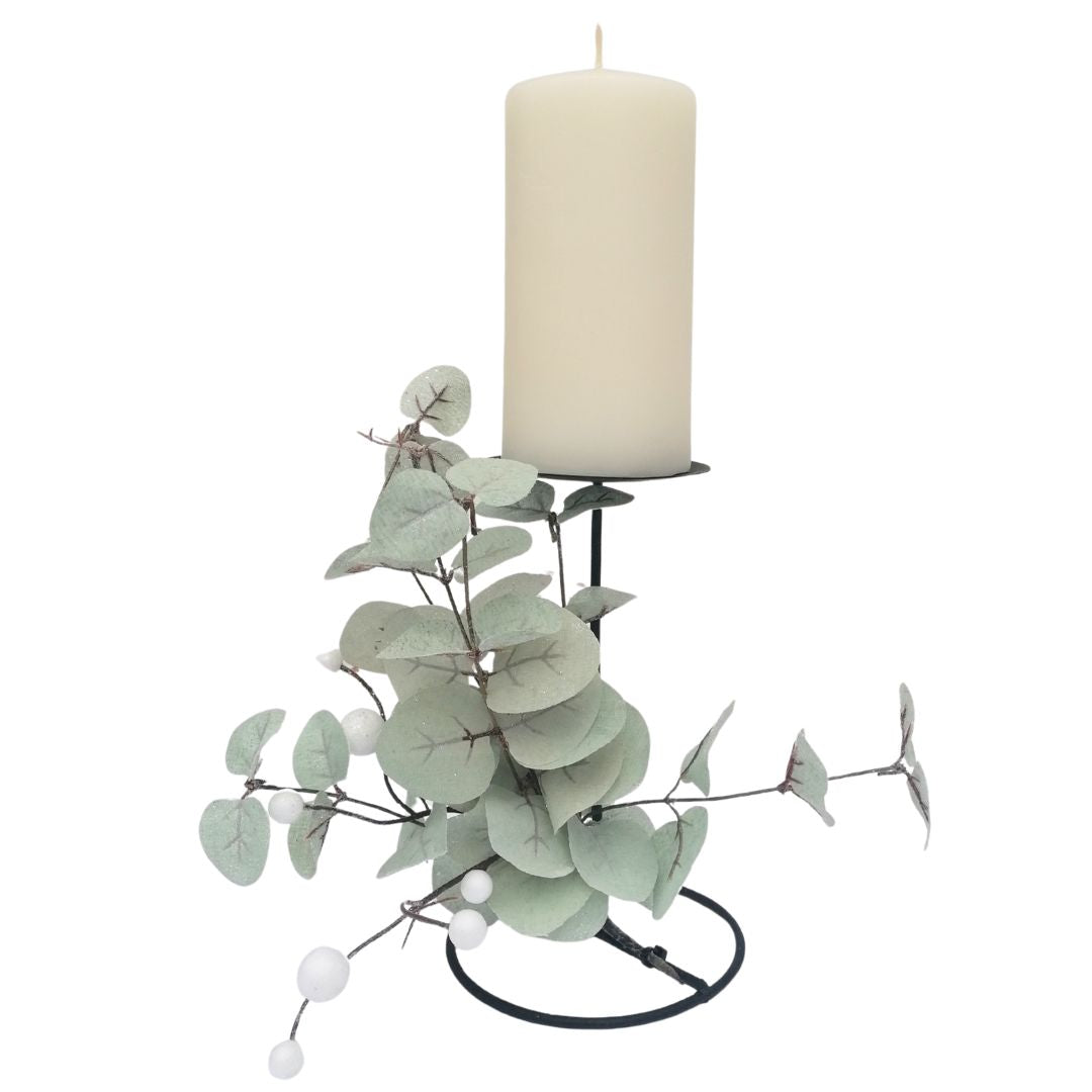 Decorative candle holder with eucalyptus branches on a white background