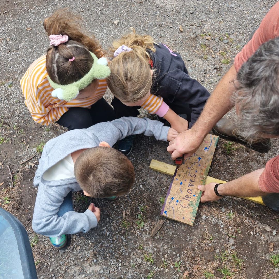 Putting together the sign on the Pumpkin Planting experience