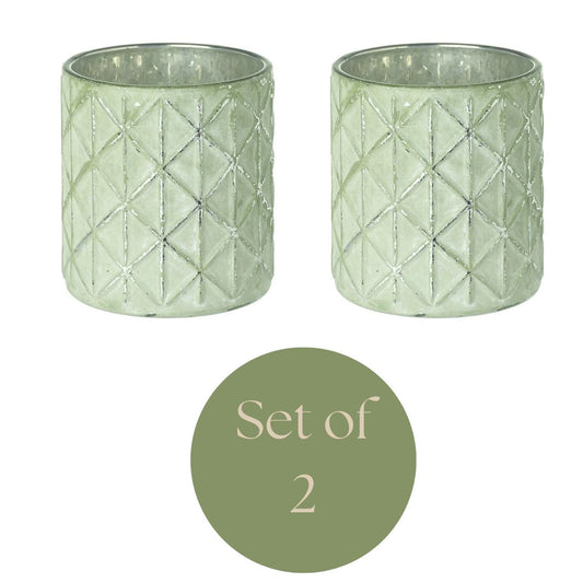 Set of 2 geometric green embossed tea light/votive holders on a white background