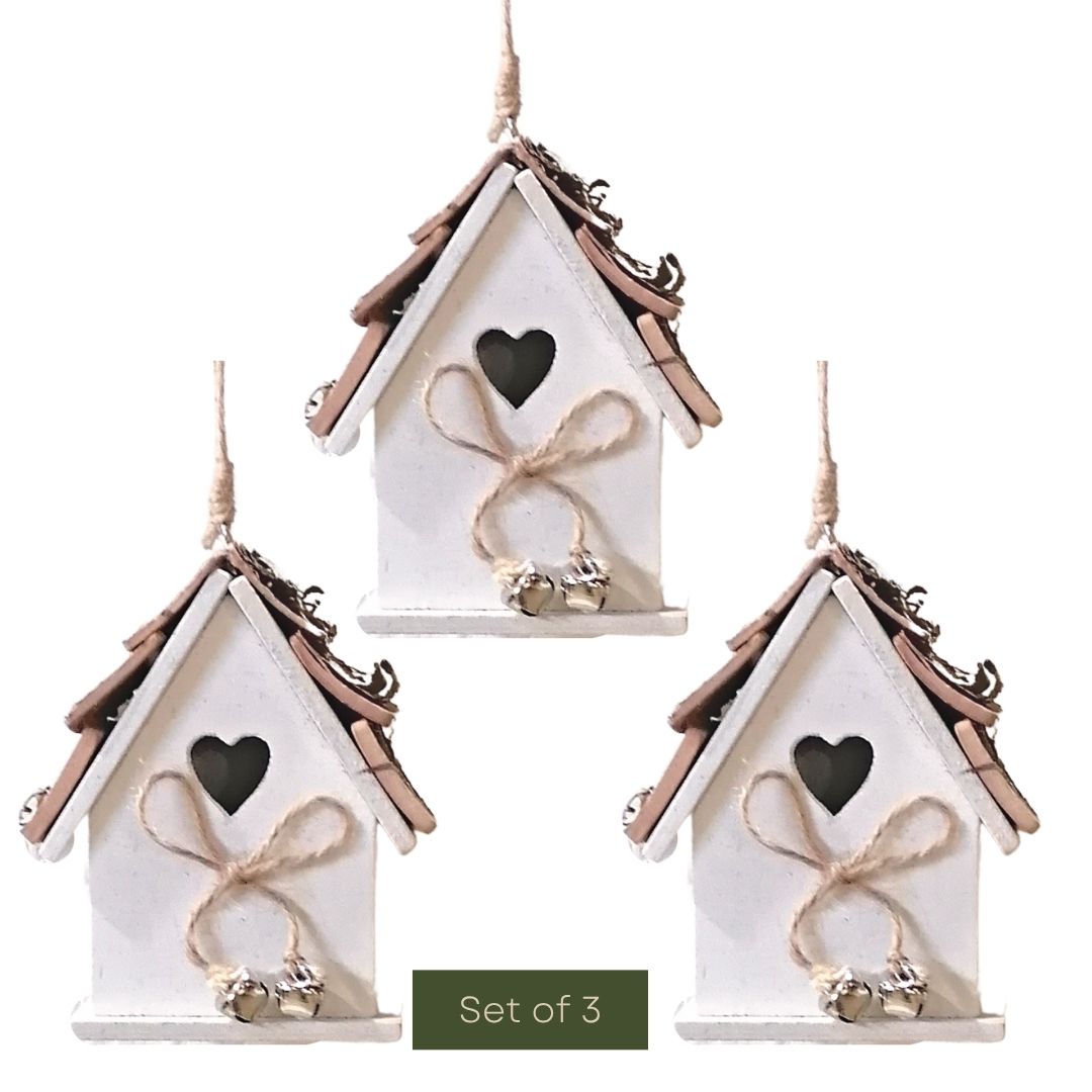 Set of three white birdhouses with brown roofs and heart windows on a white background.