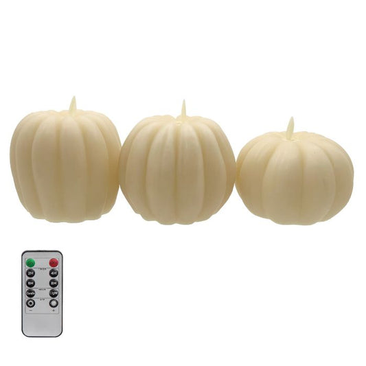 Three pumpkin-shaped candles with a remote control on a white background