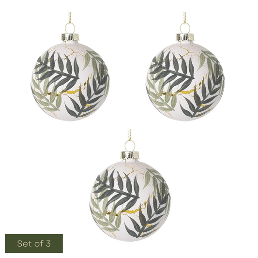 Set of three decorative Christmas balls with leaf pattern on a white background