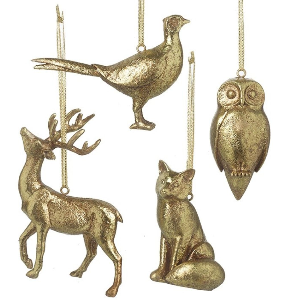 Set of gold animal ornaments including a deer, owl, fox, and pheasant on a white background