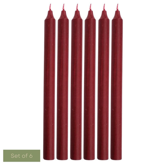 Set of six burgundy candles on a white background