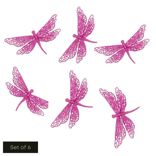White cut out product image showing 6 hot pink glittered butterfly clip on decorations arranged on the page