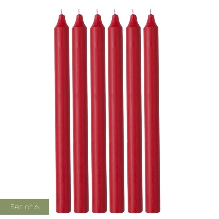 Set of six red candles on a white background