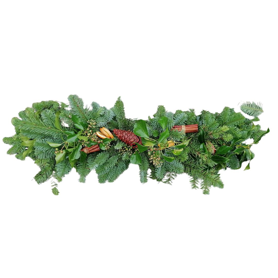 Decorative green garland with pine cones and cinnamon sticks on a white background