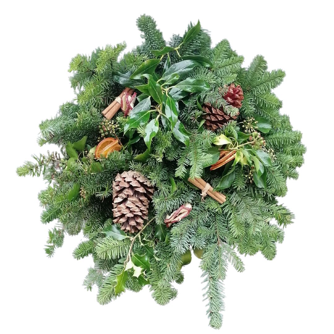 Christmas wreath with greenery, pine cones, and cinnamon sticks on a white background