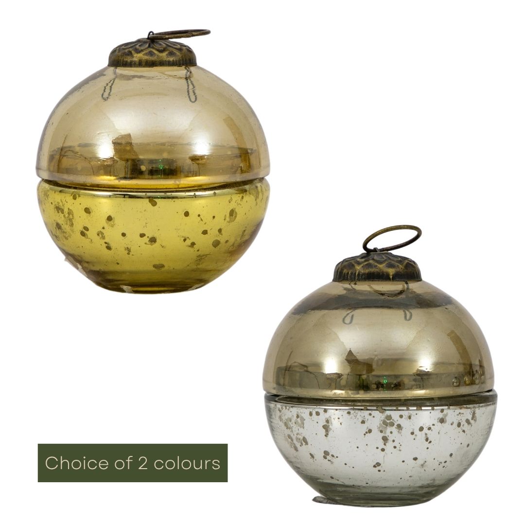 Two glass candles with metallic finishes on a white background