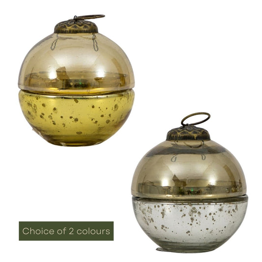 Two glass candles with metallic finishes on a white background